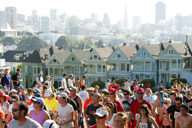 SAN FRANCISCO - MAY 17:  Participants run up Hayes Street Hill with the backdrop of the city's 'Painted Ladies' houses during the ING Bay to Breakers race May 17, 2009 in San Francisco, California.  Now in its 98th year, the ING Bay to Breakers 12K is one of the world's largest and oldest footraces, featuring world-class athletes in addition to costumed runners.  (Photo by Ezra Shaw/Getty Images)