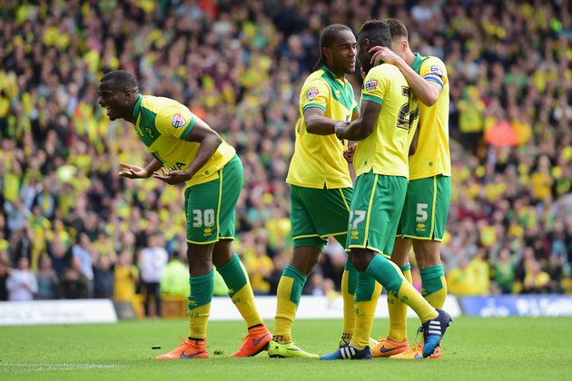 NORWICH, ENGLAND - MAY 16:  Cameron Jerome of Norwich City (2L) celebrates with team mates as he scores their third goal during the Sky Bet Championship Playoff semi final second leg match between Norwich City and Ipswich Town  at Carrow Road on May 16, 2015 in Norwich, England.  (Photo by Jamie McDonald/Getty Images)