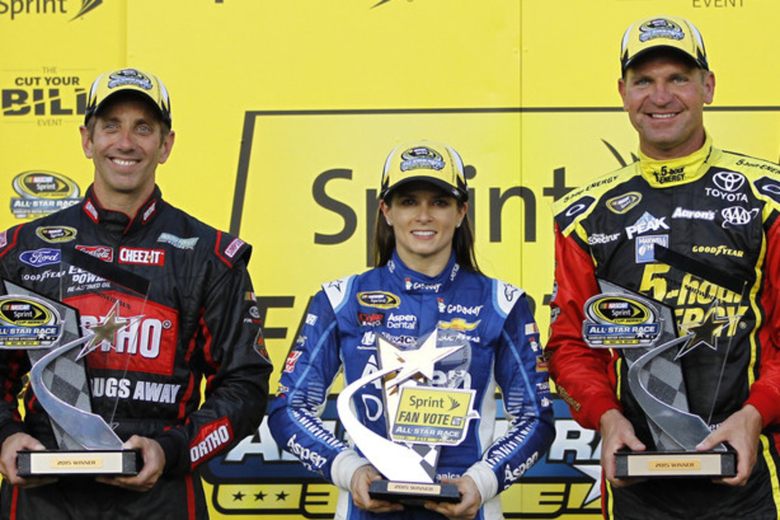 Greg Biffle, left, Danica Patrick and Clint Bowyer, right, hold their trophies in Victory Lane following the NASCAR Sprint Showdown auto race at Charlotte Motor Speedway in Concord, N.C., Friday, May 15, 2015. The three drivers will advance to Saturday's All-Star Race. (AP Photo/Terry Renna)