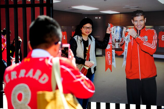 LIVERPOOL, ENGLAND - MAY 16:  Liverpool fans take photographs with Steven Gerrard picture ahead of the Barclays Premier League match between Liverpool and Crystal Palace at Anfield on May 16, 2015 in Liverpool, England.  (Photo by Stu Forster/Getty Images)