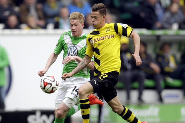 Wolfsburg's Kevin De Bruyne from Belgium, left, and Dortmund's Erik Durm, right, challenge for the ball during the German first division Bundesliga soccer match between VfL Wolfsburg and Borussia Dortmund in Wolfsburg, Germany, Saturday, May 16, 2015. (AP Photo/Michael Sohn)