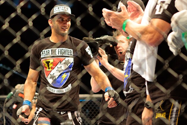Gegard Mousasi, left, receives applause after  he defats Mark Munoz from the United States  in a middleweight fight during the UFC Fight Night mixed martial arts event in Berlin, Saturday, May 31, 2014. (AP Photo/Markus Schreiber)