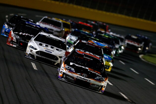 CHARLOTTE, NC - MAY 17: Denny Hamlin, driver of the #11 FedEx Express Toyota, leads the field during the NASCAR Sprint Cup Series Sprint All-Star Race at Charlotte Motor Speedway on May 17, 2014 in Charlotte, North Carolina.  (Photo by Jeff Zelevansky/Getty Images)