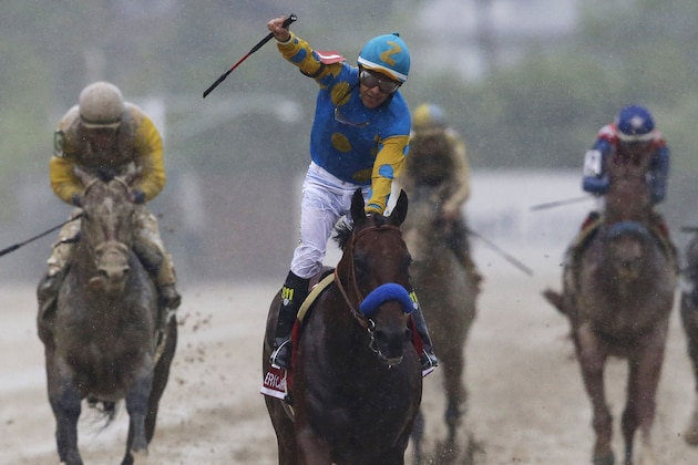 American Pharoah, ridden by Victor Espinoza, center, celebrates after winning the 140th Preakness Stakes horse race at Pimlico Race Course, Saturday, May 16, 2015, in Baltimore. (AP Photo/Patrick Semansky)