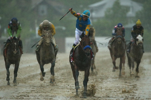 BALTIMORE, MD - MAY 16: American Pharoah #1 ridden by Victor Espinoza crosses the finish line to win the 140th running of the Preakness Stakes at Pimlico Race Course on May 16, 2015 in Baltimore, Maryland.  (Photo by Patrick Smith/Getty Images)