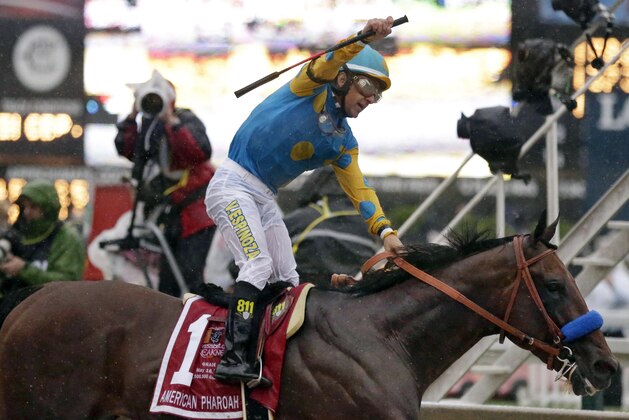 Jockey Victor Espinoza, celebrates aboard American Pharoah after winning the 140th Preakness Stakes horse race at Pimlico Race Course, Saturday, May 16, 2015, in Baltimore. (AP Photo/Brynn Anderson )