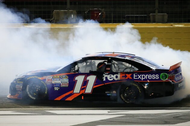 CHARLOTTE, NC - MAY 16:  Denny Hamlin, driver of the #11 FedEx Express Toyota, celebrates with a burnout after winning the NASCAR Sprint Cup Series Sprint All-Star Race at Charlotte Motor Speedway on May 16, 2015 in Charlotte, North Carolina.  (Photo by Daniel Shirey/Getty Images)