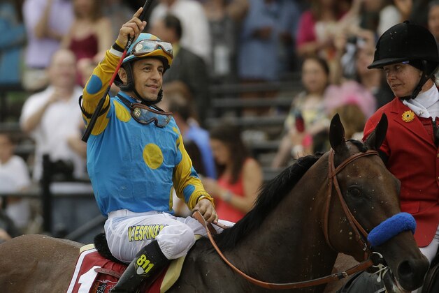 Jockey Victor Espinoza celebrates aboard American Pharoah after winning the 140th Preakness Stakes horse race at Pimlico Race Course, Saturday, May 16, 2015, in Baltimore.(AP Photo/Matt Slocum)