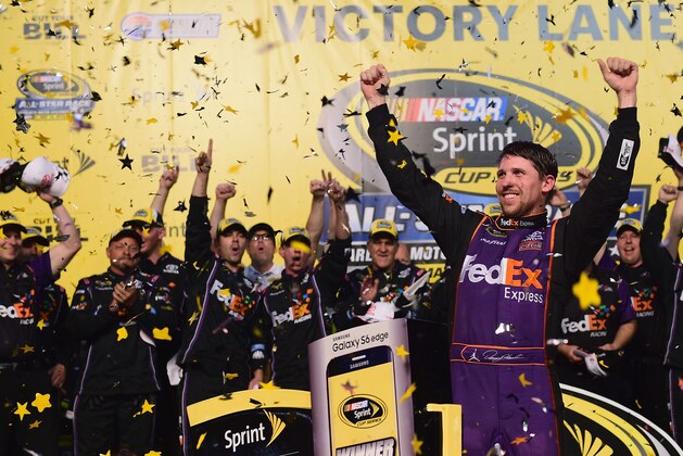 CHARLOTTE, NC - MAY 16:  Denny Hamlin, driver of the #11 FedEx Express Toyota, celebrates in victory lane after winning the NASCAR Sprint Cup Series Sprint All-Star Race at Charlotte Motor Speedway on May 16, 2015 in Charlotte, North Carolina.  (Photo by Jared C. Tilton/Getty Images)