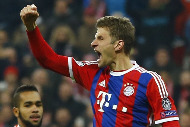 Bayern's Thomas Mueller celebrates scoring 4-0, his second goal in the match, during the Champions League round of 16 second leg soccer match between Bayern Munich and Shakhtar Donetsk Wednesday, March 11, 2015 in Munich, southern Germany. Down left corner is Shakhtar's Alex Teixeira. (AP Photo/Matthias Schrader)