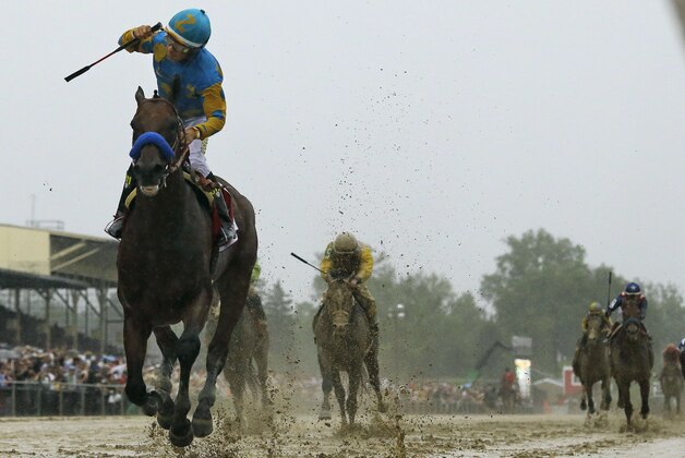 Jockey Victor Espinoza, left, celebrates aboard American Pharoah after winning the 140th Preakness Stakes horse race at Pimlico Race Course, Saturday, May 16, 2015, in Baltimore.  (AP Photo/Matt Slocum)