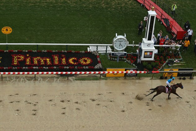 BALTIMORE, MD - MAY 16:  American Pharoah ridden by Victor Espinoza crosses the finish line to win the 140th running of the Preakness Stakes at Pimlico Race Course on May 16, 2015 in Baltimore, Maryland.  (Photo by Maddie Meyer/Getty Images)
