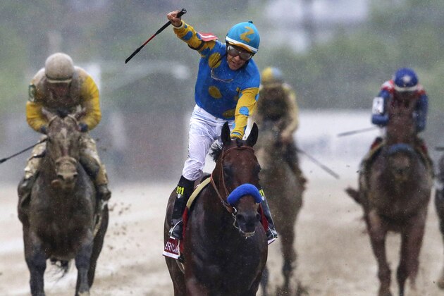 Jockey Victor Espinoza, center, celebrates aboard American Pharoah after winning the 140th Preakness Stakes horse race at Pimlico Race Course, Saturday, May 16, 2015, in Baltimore. (AP Photo/Patrick Semansky)