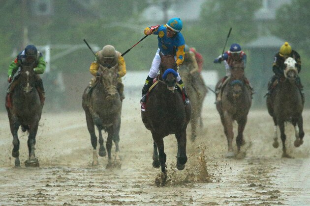 BALTIMORE, MD - MAY 16:  American Pharoah #1 ridden by Victor Espinoza crosses the finish line to win the 140th running of the Preakness Stakes at Pimlico Race Course on May 16, 2015 in Baltimore, Maryland.  (Photo by Patrick Smith/Getty Images)