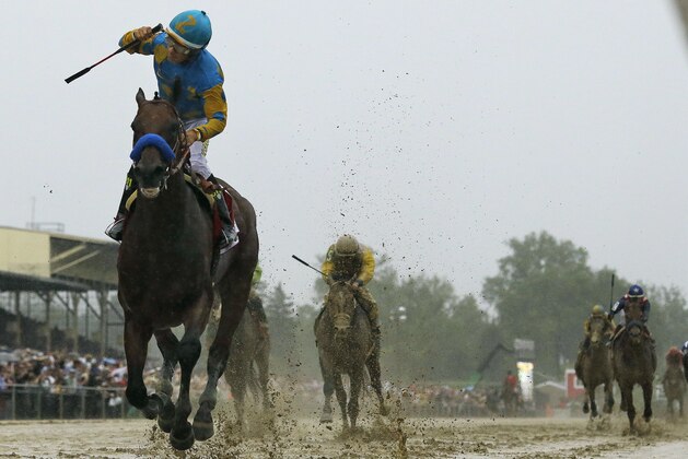 Jockey Victor Espinoza, left, celebrates aboard American Pharoah after winning the 140th Preakness Stakes horse race at Pimlico Race Course, Saturday, May 16, 2015, in Baltimore.  (AP Photo/Matt Slocum)