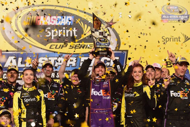 CHARLOTTE, NC - MAY 16:  Denny Hamlin, driver of the #11 FedEx Express Toyota, celebrates in victory lane after winning the NASCAR Sprint Cup Series Sprint All-Star Race at Charlotte Motor Speedway on May 16, 2015 in Charlotte, North Carolina.  (Photo by Jared C. Tilton/Getty Images)