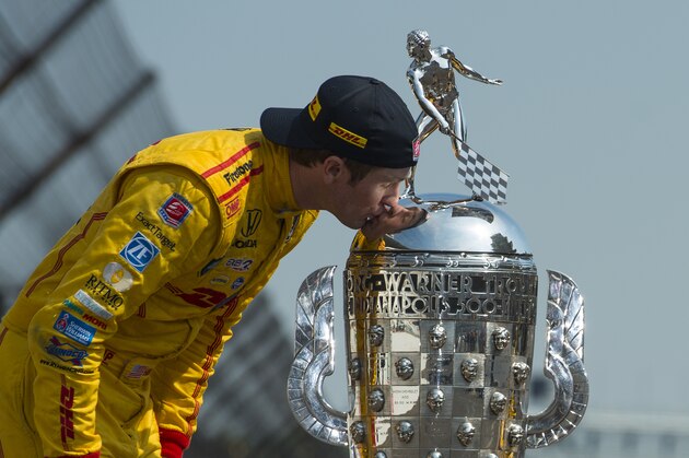 INDIANAPOLIS, IN - MAY 26: Ryan Hunter-Reay driver of the #28 Andretti Autosport Dallara Honda kisses the Borg Warner Trophy at the yard of bricks during the Indianapolis 500 Mile Race Trophy Presentation and Champions Portrait Session at the Indianapolis Motor Speedway on May 26, 2014 in Indianapolis, Indiana.  (Photo by Robert Laberge/Getty Images)