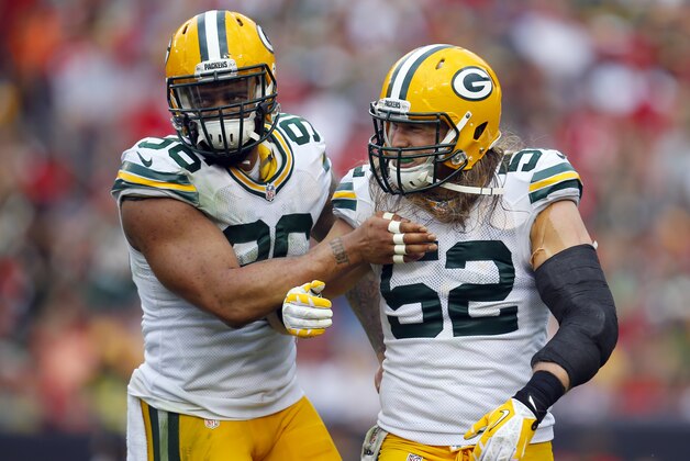 Green Bay Packers outside linebacker Julius Peppers (56) hugs teammate Clay Matthews (52) after a sack against the Tampa Bay Buccaneers during an NFL football game Sunday, Dec. 21, 2014, in Tampa, Fla. The Packers won 20-3. (Jeff Haynes/AP Images for Panini)