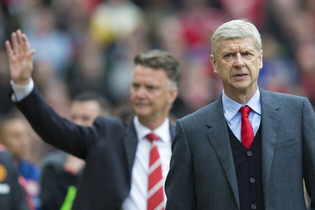 Arsenal's manager Arsene Wenger, right, and Manchester United manager Louis van Gaal take to the touchline before the English Premier League soccer match between Manchester United and Arsenal at Old Trafford Stadium, Manchester, England, Sunday, May 17, 2015. (AP Photo/Jon Super)