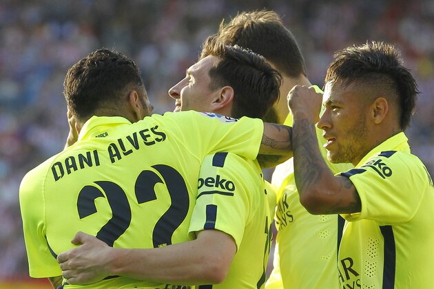Barcelona's Lionel Messi, 2nd left, celebrates with team mates after scoring during a Spanish La Liga soccer match between Atletico Madrid and Barcelona at the Vicente Calderon stadium in Madrid, Spain, Sunday May 17, 2015. (AP Photo/Paul White)
