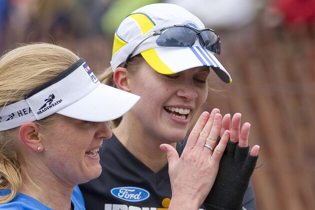 Runners congratulate each other after finishing the Twin Cities Marathon on Sunday, Oct. 5, 2014 in St. Paul, Minn. (AP Photo/Andy Clayton-King)