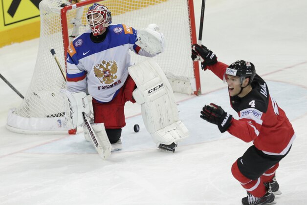 Russia’s goalkeeper Sergei Bobrovski, left, reacts missing team's third goal from Canada’s Canada’s Sidney Crosby, unseen, during the Hockey World Championships gold medal match in Prague, Czech Republic, Sunday, May 17, 2015. (AP Photo/Sergei Grits)