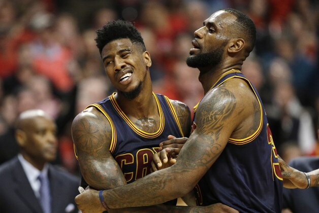 Cleveland Cavaliers guard Iman Shumpert (4) is held by  LeBron James (23) against the Chicago Bulls during the first half of Game 6 in a second-round NBA basketball playoff series in Chicago on Thursday, May 14, 2015. (AP Photo/Nam Y. Huh)