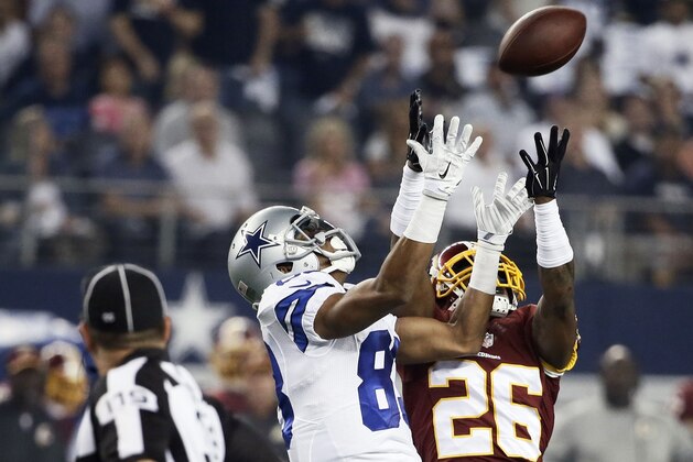 Dallas Cowboys wide receiver Terrance Williams (83) misses a reception as Washington Redskins cornerback Bashaud Breeland (26) defends during the first half of an NFL football game, Monday, Oct. 27, 2014, in Arlington, Texas. (AP Photo/Brandon Wade)