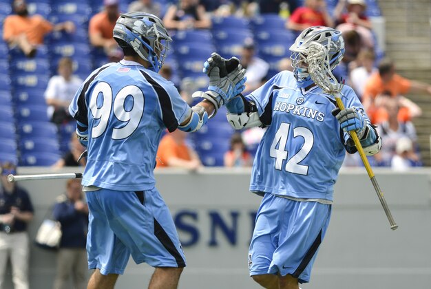 May 17, 2015; Annapolis, MD, USA;  Johns Hopkins Blue Jays attack Wells Stanwick (42) celebrates with midfielder Holden Cattoni (99) after scoring a goal during the first half against the Syracuse Orange at Navy Marine Corps Memorial Stadium. Mandatory Credit: Tommy Gilligan-USA TODAY Sports