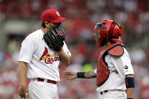 St. Louis Cardinals starting pitcher John Lackey, left, talks with catcher Yadier Molina during the seventh inning of a baseball game against the Chicago Cubs Thursday, May 7, 2015, in St. Louis. The Cardinals won 5-1. (AP Photo/Jeff Roberson)