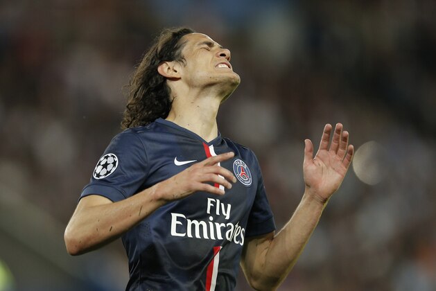 PSG's Edinson Cavani reacts after a missed opportunity during the quarterfinal first leg Champions League soccer match between Paris Saint Germain and Barcelona at the Parc des Princes stadium in Paris, France, Wednesday, April 15, 2015. (AP Photo/Christophe Ena)