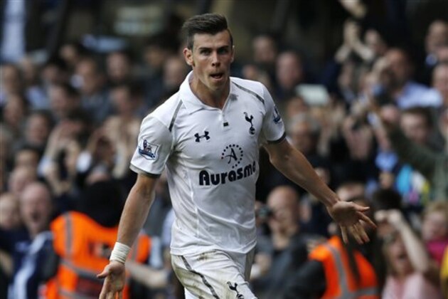 FILE- Soccer player Gareth Bale in action playing for English club Tottenham Hotspur, celebrating his goal against Sunderland during their English Premier League soccer match at White Hart Lane, London, in this file photo dated Sunday, May 19, 2013. After the year's most drawn-out transfer saga, it's finally official, that Gareth Bale is now a Real Madrid player after Madrid announced Sunday Sept. 1, 2013,  that Bale has signed a six-year contract. (AP Photo/Sang Tan, FILE)