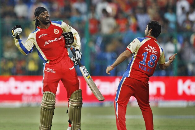 Royal Challengers Bangalore's Chris Gayle, left, and Virat Kohli celebrate their win over Chennai Super Kings during their Indian Premier League (IPL) cricket match in Bangalore, India, Sunday, May 22, 2011. (AP Photo/Aijaz Rahi)
