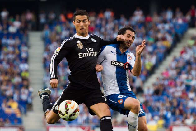 BARCELONA, SPAIN - MAY 17: Cristiano Ronaldo (L) of Real Madrid CF fights for the ball with Victor Sanchez (R) of RCD Espanyol during the La Liga match between RCD Espanyol and Real Madrid CF at Cornella-El Prat Stadium on May 17, 2015 in Barcelona, Spain. (Photo by Alex Caparros/Getty Images)