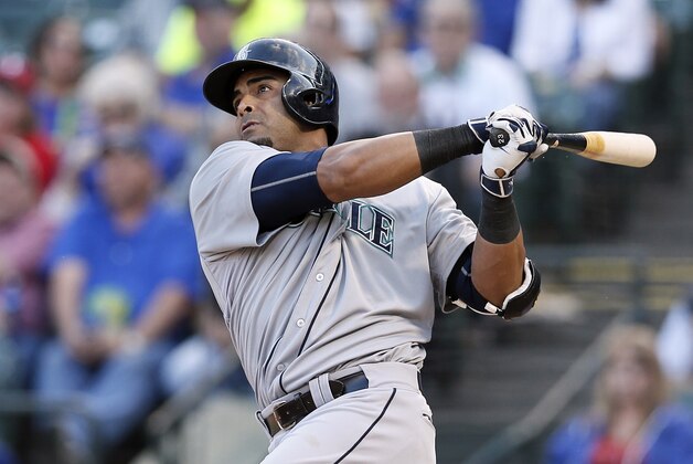 Seattle Mariners' Nelson Cruz follows through on a solo home run off of Texas Rangers' Wandy Rodriguez during a baseball game Wednesday, April 29, 2015, in Arlington, Texas. (AP Photo/Tony Gutierrez)