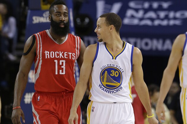 Golden State Warriors guard Stephen Curry (30) smiles next to Houston Rockets guard James Harden (13) during the first half of an NBA basketball game in Oakland, Calif., Wednesday, Jan. 21, 2015. (AP Photo/Jeff Chiu)