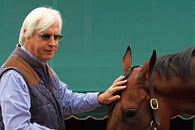 Hall of Fame trainer Bob Baffert rubs the head of American Pharoah as the Preakness-winning colt gets a bath outside the stakes barn Sunday, May 17, 2015, at Pimlico Race Course in Baltimore.  (AP Photo/Garry Jones)