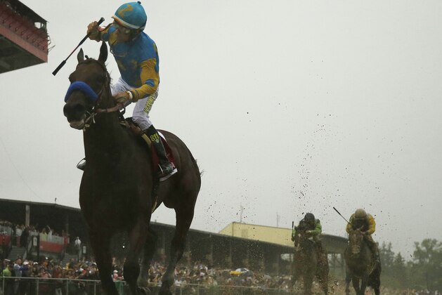 American Pharoah, ridden by Victor Espinoza  wins the 140th Preakness Stakes horse race at Pimlico Race Course, Saturday, May 16, 2015, in Baltimore. (AP Photo/Matt Slocum)
