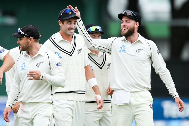 WELLINGTON, NEW ZEALAND - JANUARY 07:  Mark Craig of New Zealand celebrates the series win with teammate Tim Southee during day five of the Second Test match between New Zealand and Sri Lanka at Basin Reserve on January 7, 2015 in Wellington, New Zealand.  (Photo by Hagen Hopkins/Getty Images)