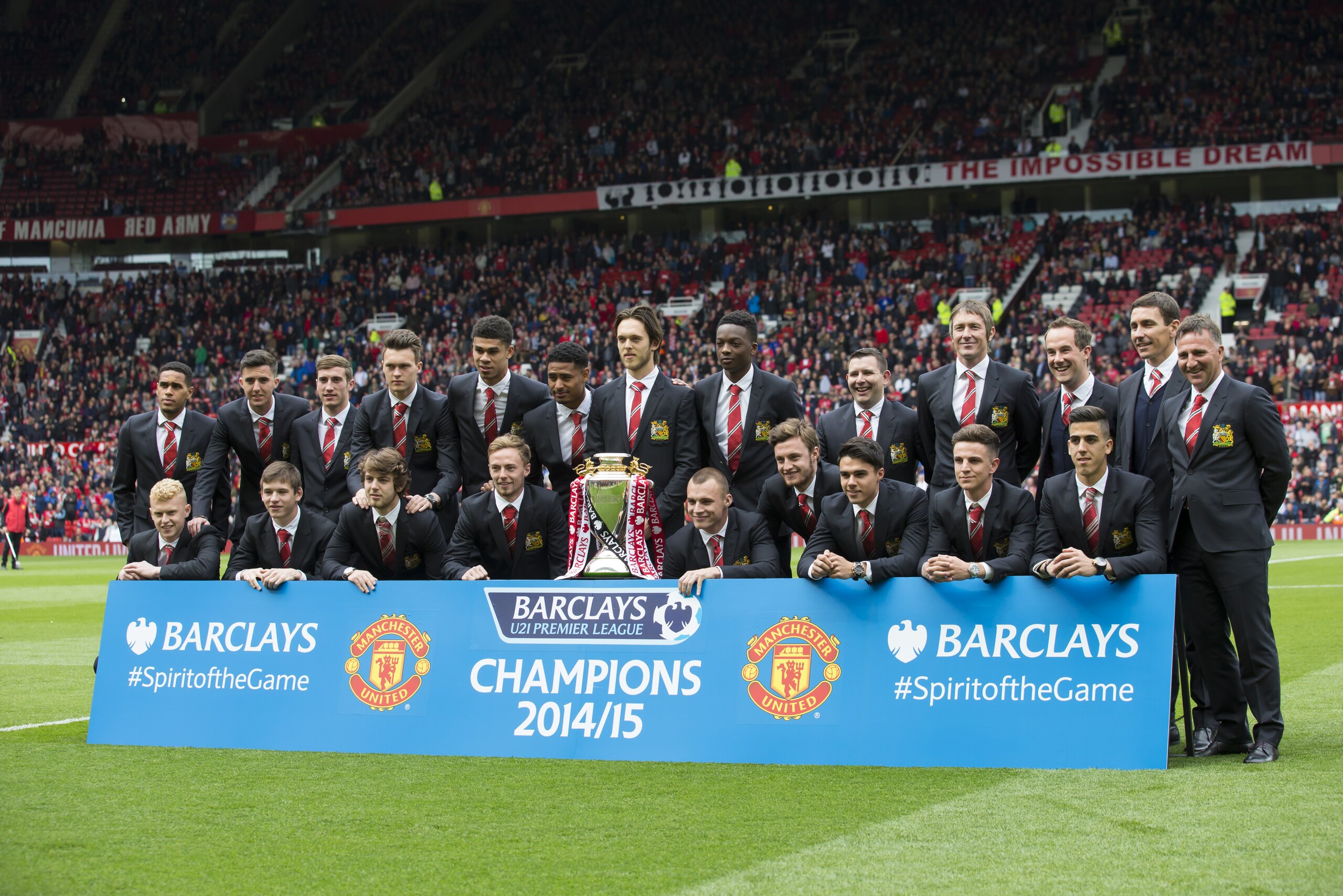 Manchester United's Under 21 team poses with their trophy after winning the under 21 Premier League before the English Premier League soccer match between Manchester United and Arsenal at Old Trafford Stadium, Manchester, England, Sunday, May 17, 2015. (AP Photo/Jon Super)