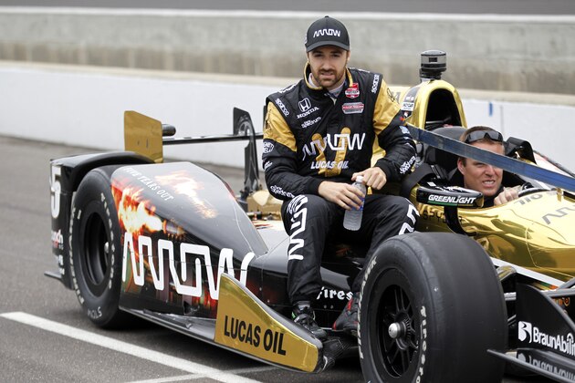 James Hinchcliffe, of Canada, rides on his car out to the pit area during practice on the first day of qualifications for the Indianapolis 500 auto race at Indianapolis Motor Speedway in Indianapolis, Saturday, May 16, 2015.  (AP Photo/AJ Mast)