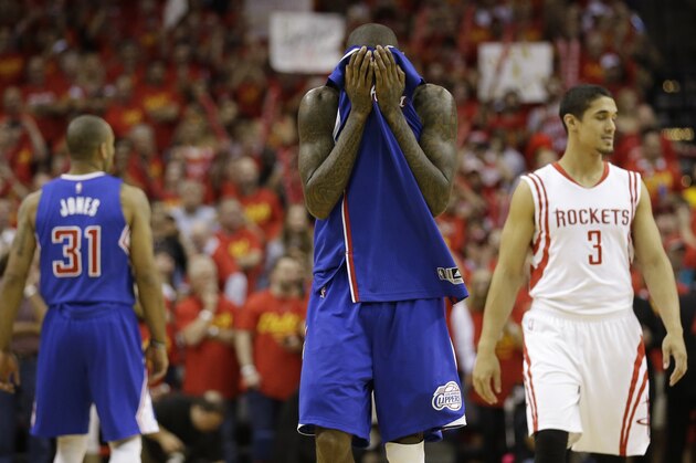 Los Angeles Clippers' Jamal Crawford covers his face as he walks down the court in the closing seconds of the second half in Game 7 of the NBA basketball Western Conference semifinals against the Houston Rockets Sunday, May 17, 2015, in Houston. The Rockets won 113-100. (AP Photo/David J. Phillip)