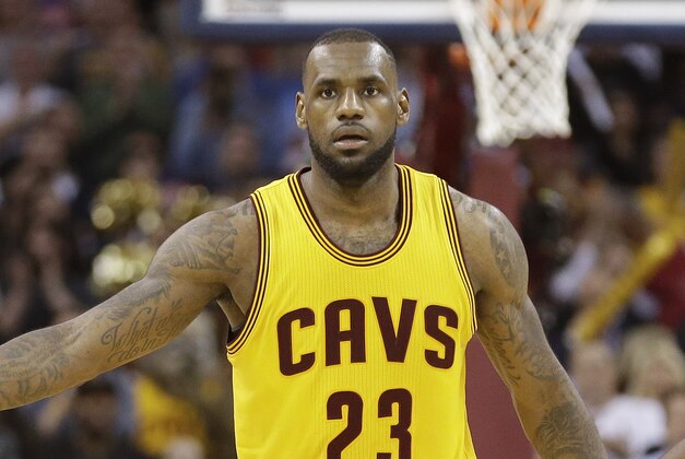 Cleveland Cavaliers forward LeBron James slaps hands with a teammate after scoring against the Chicago Bulls during the second half of Game 5 in a second-round NBA basketball playoff series Tuesday, May 12, 2015, in Cleveland. The Cavaliers won 106-101. (AP Photo/Tony Dejak)