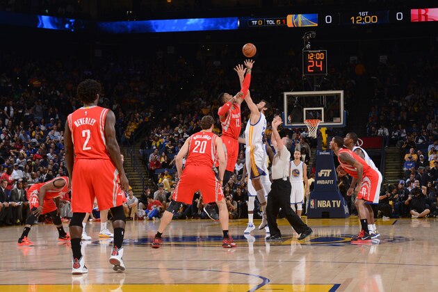 OAKLAND, CA - JANUARY 21: Dwight Howard #12 of the Houston Rockets jumps for the tip off against Andrew Bogut #12 of the Golden State Warriors on January 21, 2015 at Oracle Arena in Oakland, California. NOTE TO USER: User expressly acknowledges and agrees that, by downloading and or using this photograph, user is consenting to the terms and conditions of Getty Images License Agreement. Mandatory Copyright Notice: Copyright 2015 NBAE (Photo by Noah Graham/NBAE via Getty Images)