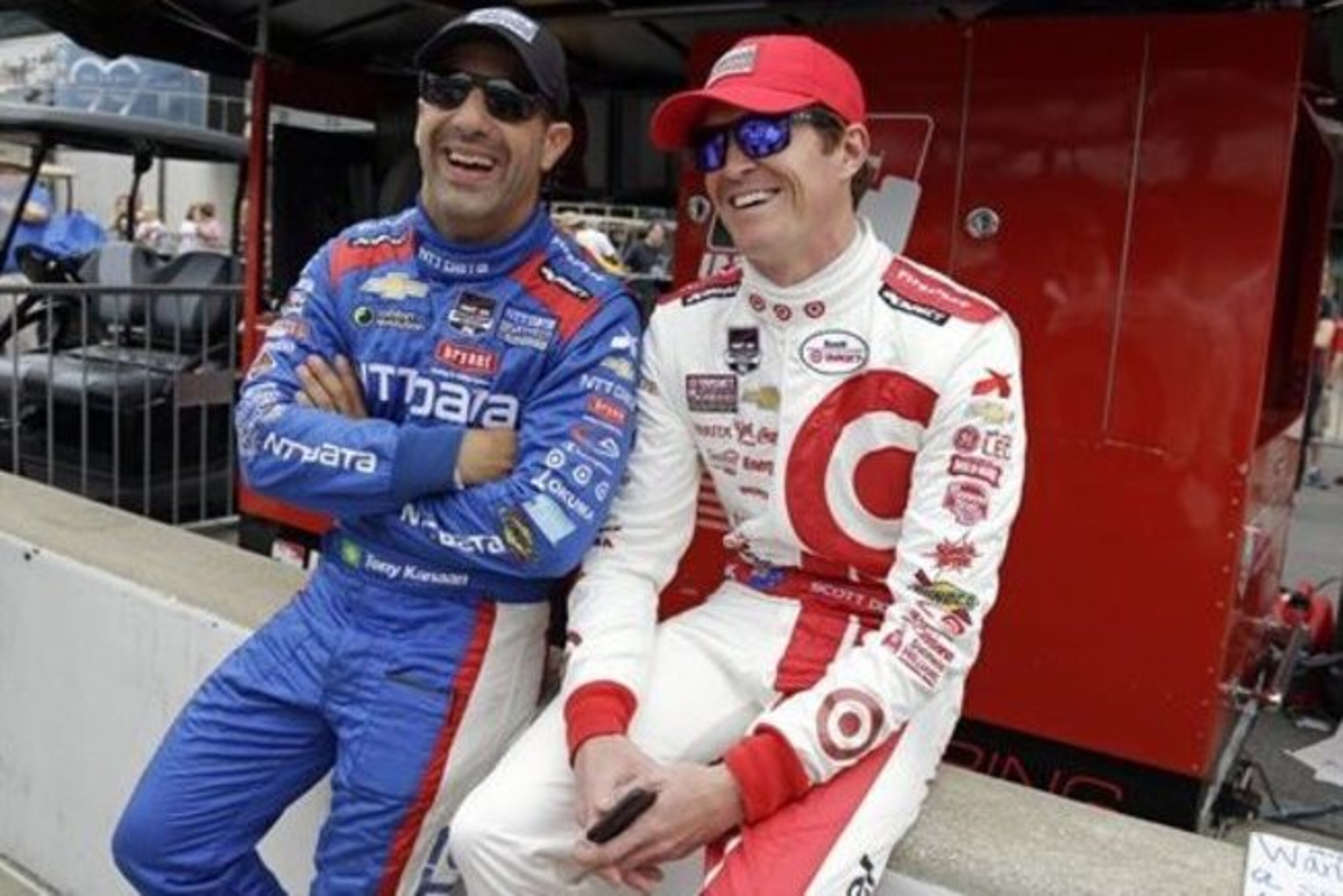 Tony Kanaan, of Brazil, left, and Scott Dixon, of New Zealand, joke as they wait to pose for a group photo of the starting lineup before the start of practice for the Indianapolis 500 auto race at Indianapolis Motor Speedway in Indianapolis, Monday, May 18, 2015.  (AP Photo/Michael Conroy)