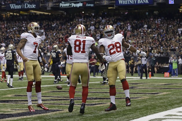 San Francisco 49ers running back Carlos Hyde (28) celebrates his touchdown carry with quarterback Colin Kaepernick (7) and wide receiver Anquan Boldin (81) in the first half of an NFL football gameagainst the New Orleans Saints in New Orleans, Sunday, Nov. 9, 2014. (AP Photo/Jonathan Bachman)