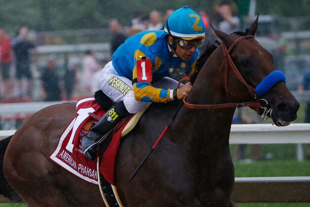 May 16, 2015; Baltimore, MD, USA; Victor Espinoza aboard American Pharoah leads the pack out of turn four during the 140th Preakness Stakes at Pimlico Race Course. Mandatory Credit: Geoff Burke-USA TODAY Sports
