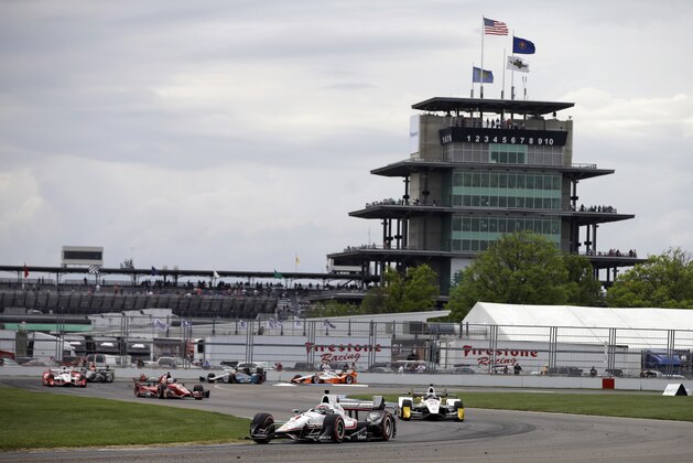 Will Power, of Australia, leads the field through a turn during the Grand Prix of Indianapolis auto race at Indianapolis Motor Speedway in Indianapolis, Saturday, May 9, 2015. Power won the race. (AP Photo/Darron Cummings)