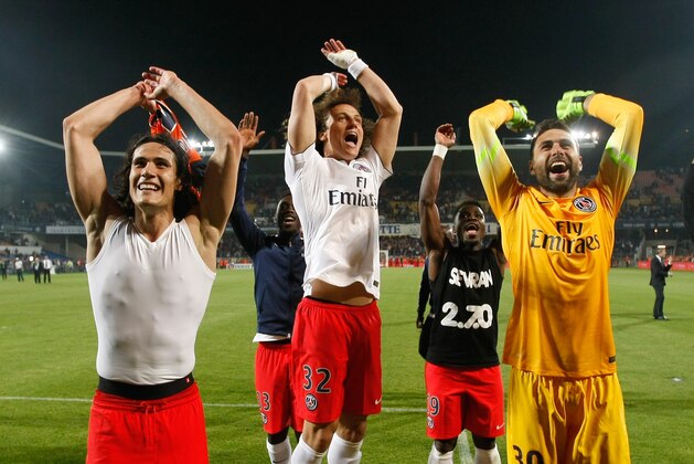 Paris Saint Germain's Uruguayan forward Edinson Cavani, left, defender David Luiz, center,  Italian goalkepper Salvatore Sirigu, celebrate, after defeating  Montpellier, and winning  the French League One title, at the end of the League One soccer match between Montpellier and Paris Saint-Germain, at the La Mosson Stadium, in Montpellier, southern France, Saturday, May 16, 2015.   (AP Photo/Claude Paris)