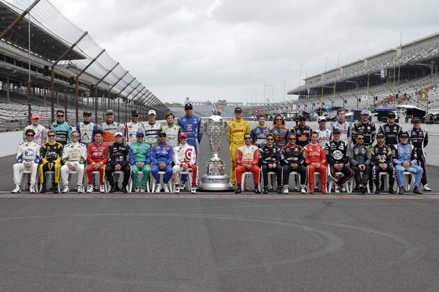 The starting line up for the Indianapolis 500 pose on the start/finish line before the start of practice for the Indianapolis 500 auto race at Indianapolis Motor Speedway in Indianapolis, Monday, May 18, 2015.  (AP Photo/Darron Cummings)